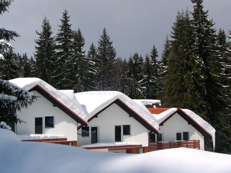 Three chalets in the winter covered with snow. Three chalets in the winter covered with snow.