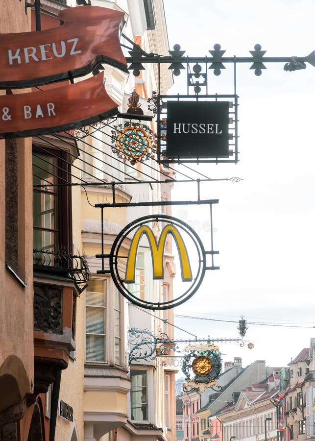 Mcdonalds sign en la histórica ciudad de innsbruck es una cadena de comida rápida norteamericana de fama mundial fotos de archivo libres de regalías