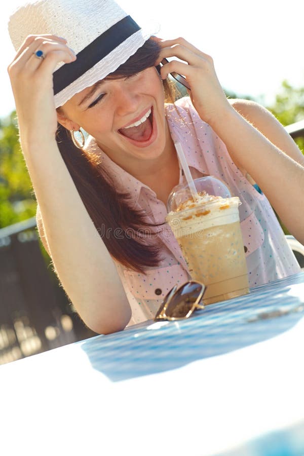 You crack me up. An adolescent girl laughing as she speaks on her cellphone while sitting at an outdoor cafe. You crack me up. An adolescent girl laughing as she speaks on her cellphone while sitting at an outdoor cafe