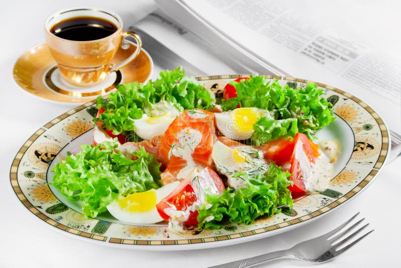 Meal, coffee cup and newspaper on table