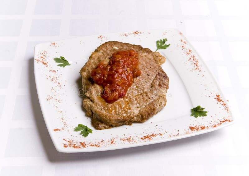 Meal cutlet with tomatoes sauce