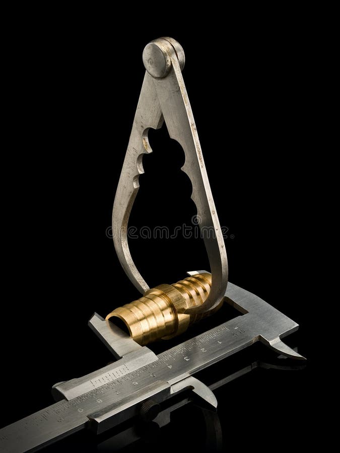 Measurement of the Sizes of the Brass Plug by Two Calipers Stock Image