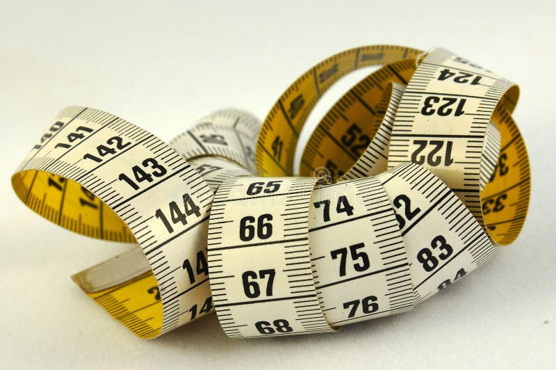 An old used yellow and white measurement in centimeters and millimeters on grayish background. Weight watchers stock images, royalty-free photos and pictures