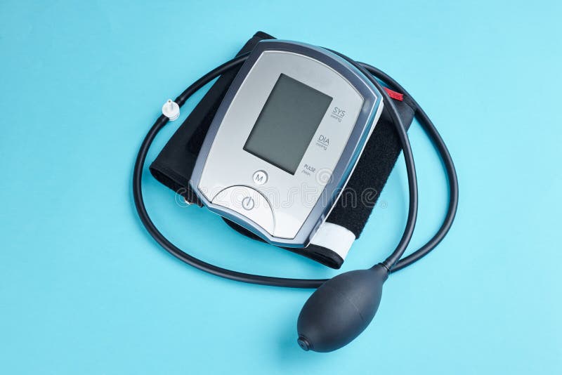 Measuring Blood Pressure with Electronic Medical Device Over Blue