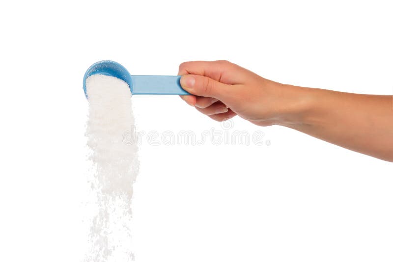 Measuring cup with washing powder in hand royalty free stock photos