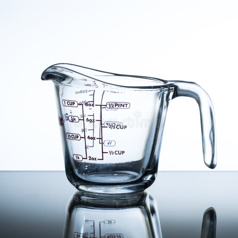 Oil In Measuring Cup On Table In Kitchen Stock Photo, Picture and