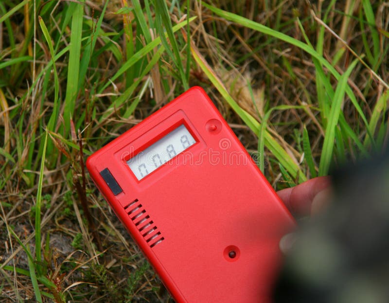 Worker measuring environmental radiation level by dosimeter. Worker measuring environmental radiation level by dosimeter