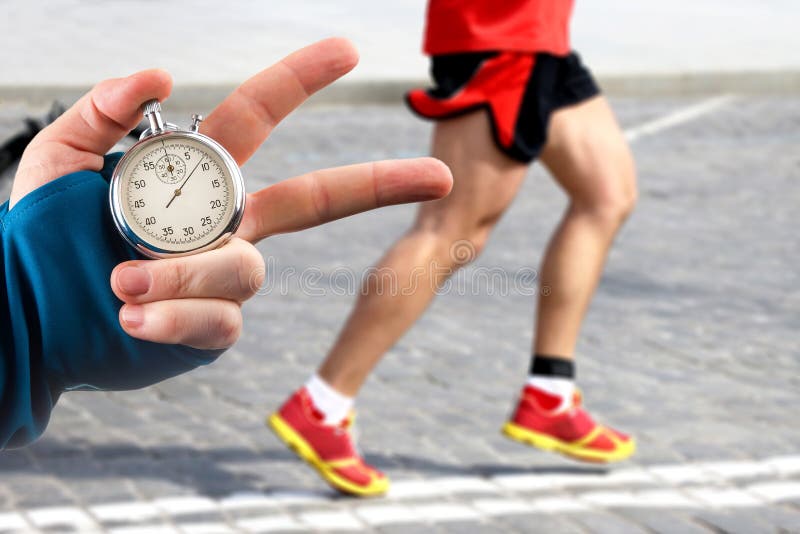 Measuring the Running Speed of an Athlete Using a Mechanical Stopwatch.  Hand with a Stopwatch on the Background of the Legs of a Stock Image -  Image of chronometer, monitor: 257808953