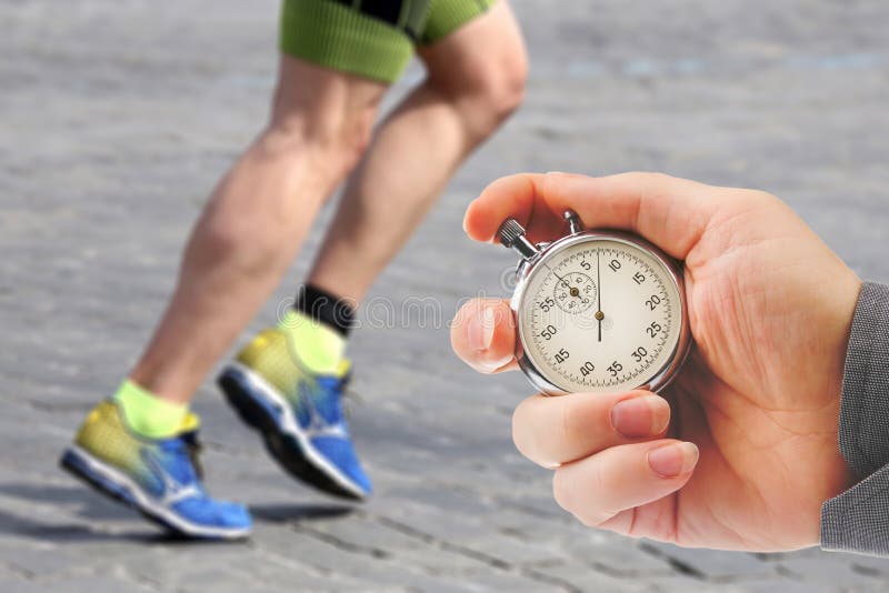 Measuring the Running Speed of an Athlete Using a Mechanical Stopwatch.  Hand with a Stopwatch on the Background of the Legs of a Stock Image -  Image of chronometer, monitor: 257808953