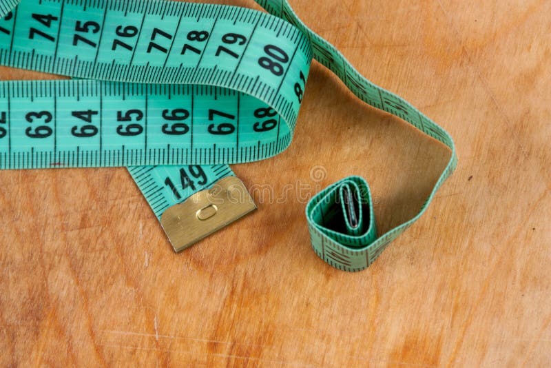 Measuring Tape on Wooden Background Stock Image - Image of closeup
