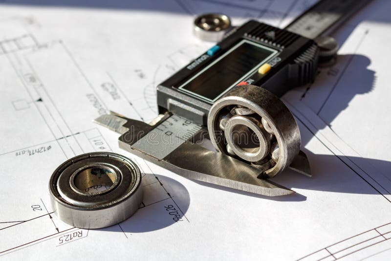 Measuring of the used ball bearings height by electronic caliper royalty free stock photos Measuring of the used ball bearings height by electronic caliper royalty free stock photos