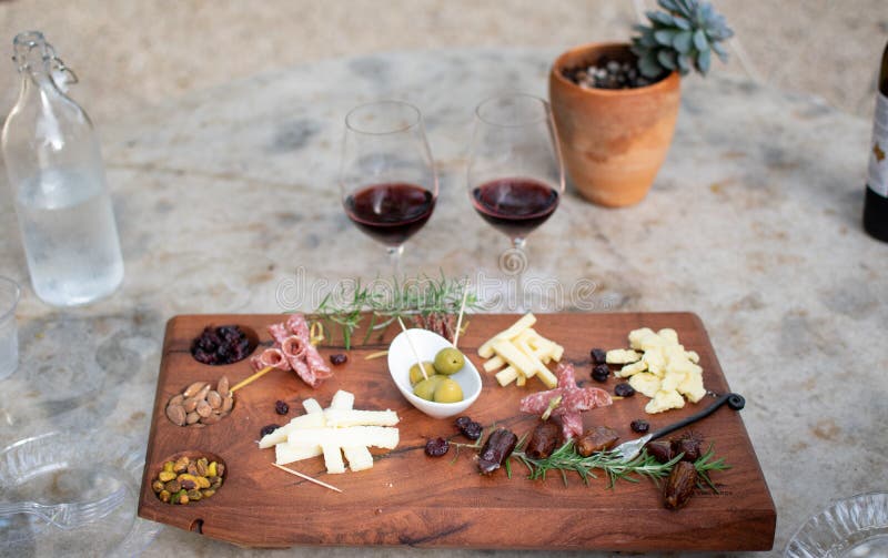 Meat and Cheese Board with Wine Glasses at a Winery Stock Photo Image