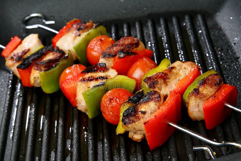 Meat, cherry tomato and red and green pepper skewe