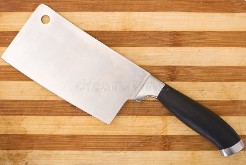 Meat cleaver isolated over wooden background