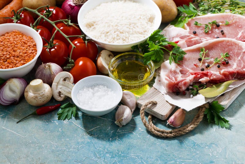 meat and fresh foods for cooking soup on a blue background