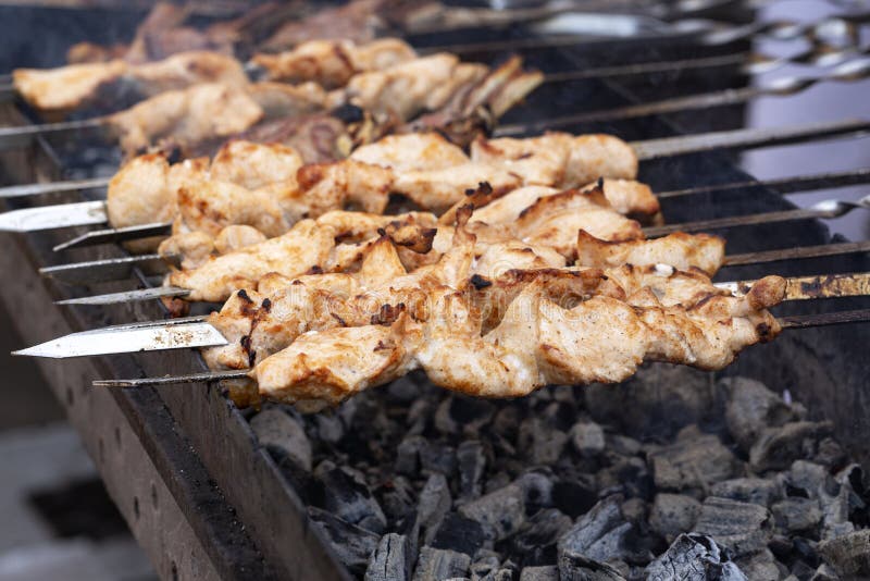 The meat is grilled skewers on a barbecue grill. Delicious bbq kebab grilling on open grill, outdoor kitchen. Food tasty food roa stock images The meat is grilled skewers on a barbecue grill. Delicious bbq kebab grilling on open grill, outdoor kitchen. Food tasty food roa stock images