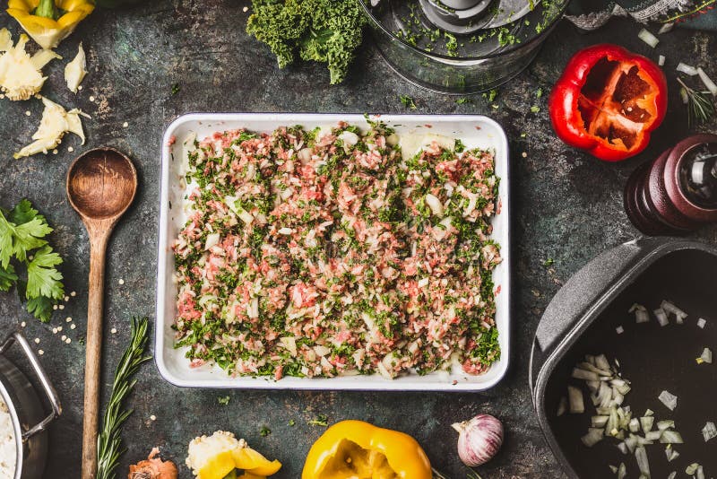 Meat stuffing with ground meat, rice and chopped kale for paprika filling on rustic kitchen table background with wooden cooking stock photography Meat stuffing with ground meat, rice and chopped kale for paprika filling on rustic kitchen table background with wooden cooking stock photography