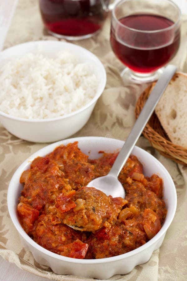 Meat with tomato sauce with spoon