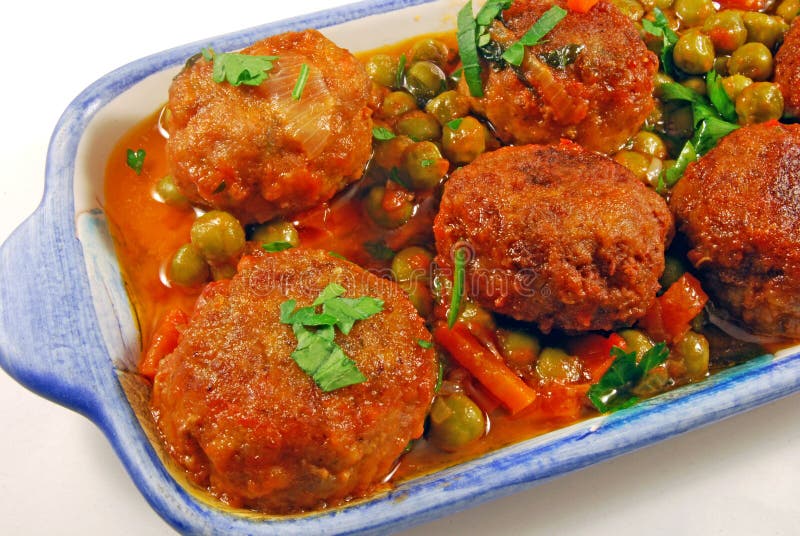 Meatballs in sauce with peas