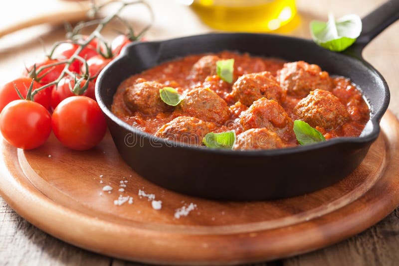 Meatballs with tomato sauce in black pan