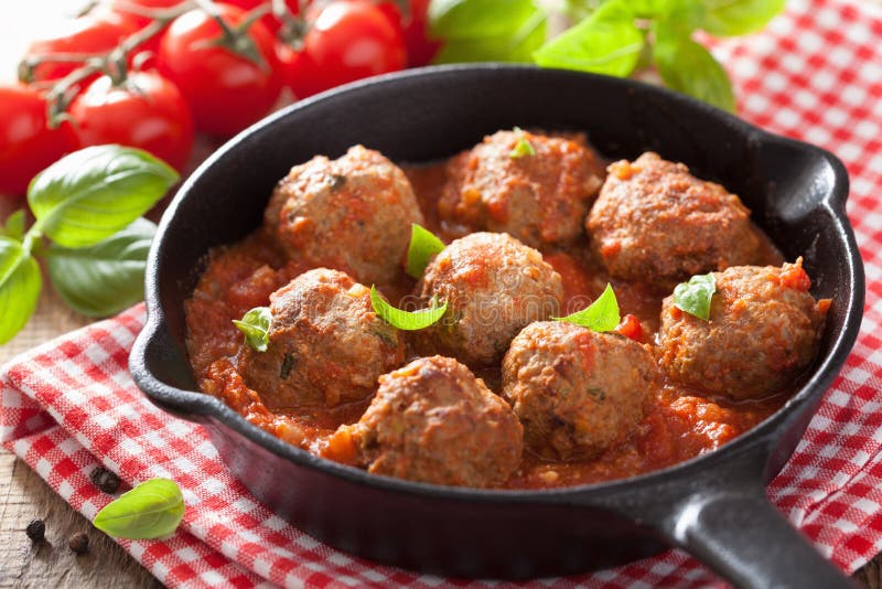 Meatballs with tomato sauce in black pan