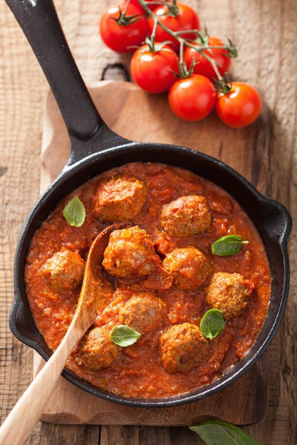 Meatballs with tomato sauce in black pan