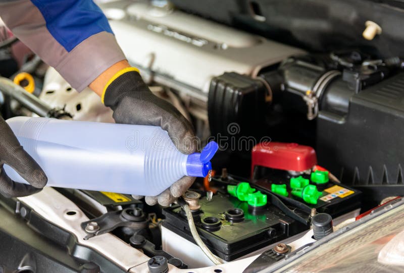 The Mechanic Adds Distilled Water Check the Car Battery Stock Photo