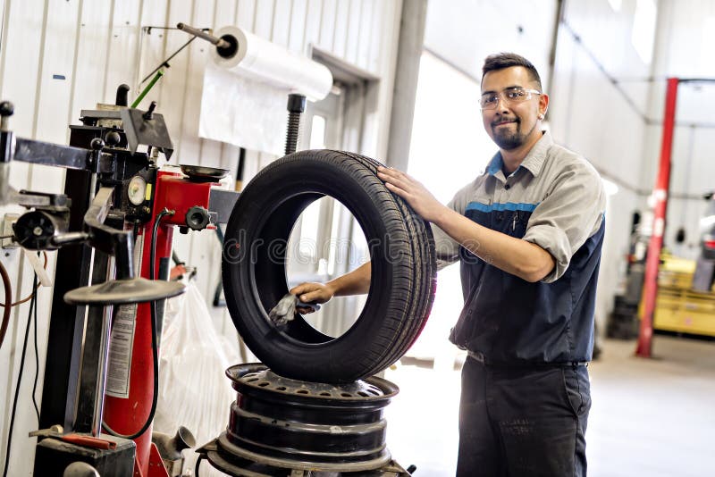 Mechanic Changing Car Tire at Work Stock Image Image of friendly