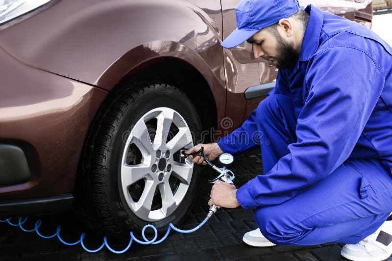 Mechanic Checking Tire Air Pressure at Car Service Stock Image Image