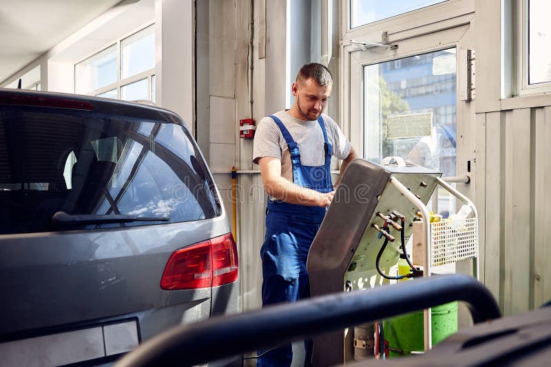 Mechanic checks air conditioning system in car auto service stock image