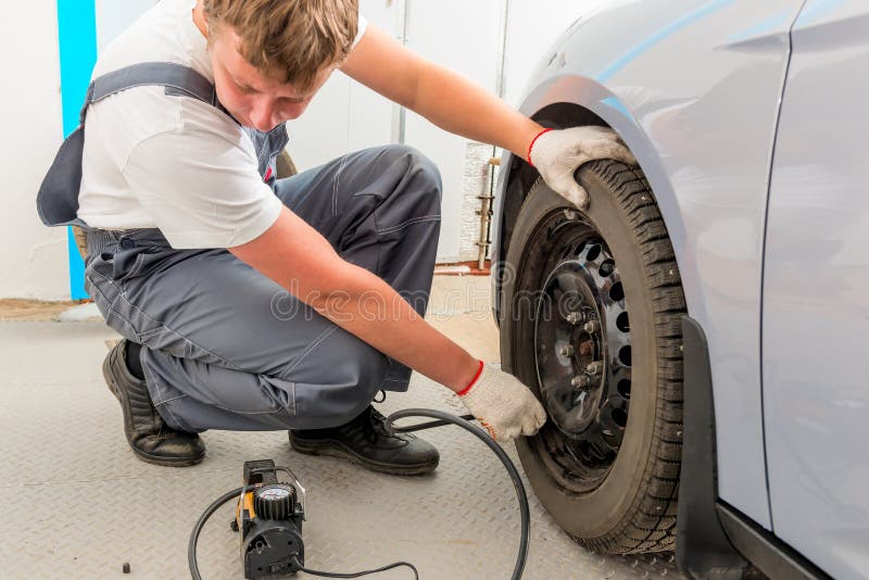 Mechanic checks the degree of wheel pump royalty free stock images