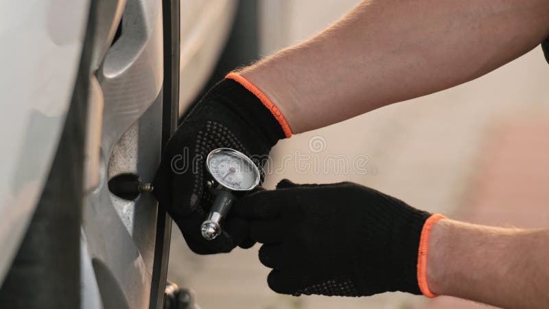 Mechanic Checks Tire Pressure royalty free stock photos