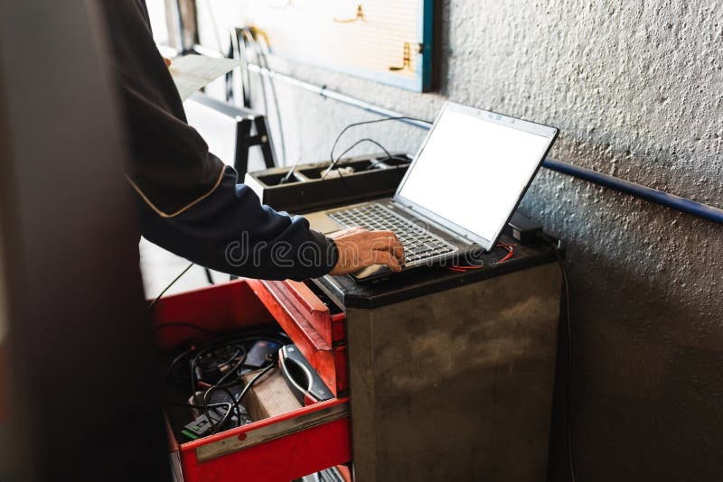 Mechanic diagnosing the car with the computer. Concept of car repair.