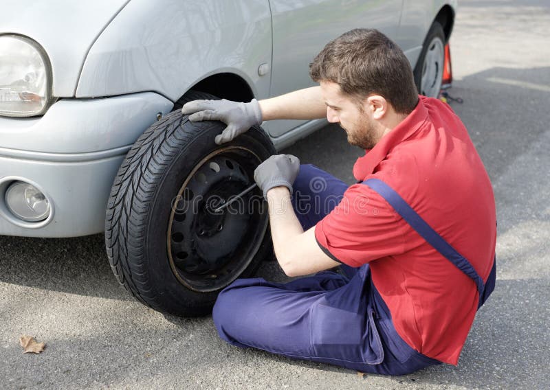 Mechanic fixing a car problem stock image