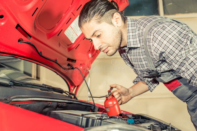 Mechanic fixing and checking a car royalty free stock photo