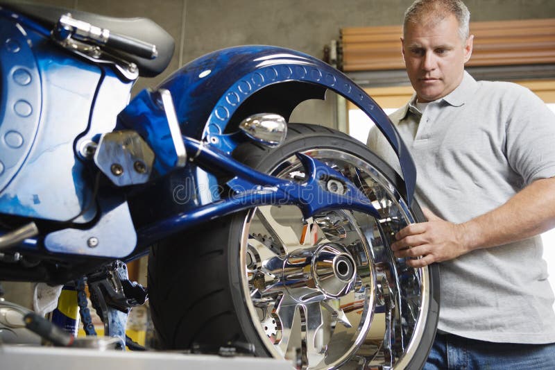 Mechanic Fixing Motorcycle stock photo