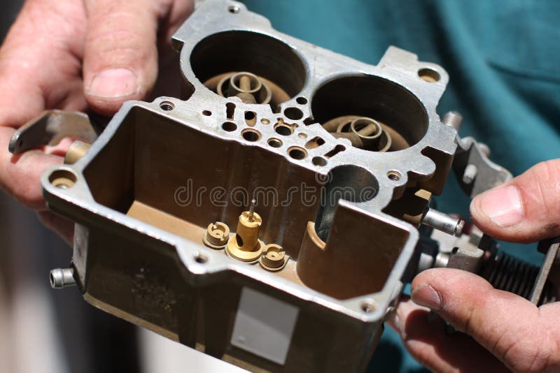 Mechanic holds carburetor stock image. Image of power 6990923