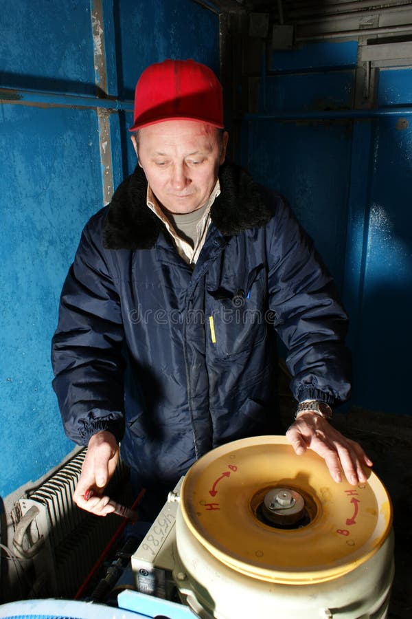 Mechanic makes repair of elevators stock photo
