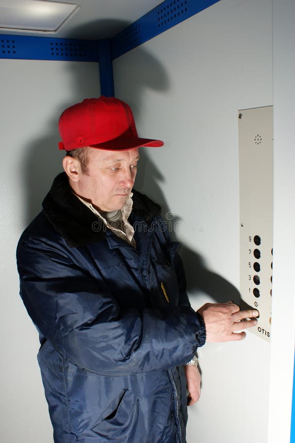 Mechanic makes repair of elevators royalty free stock images