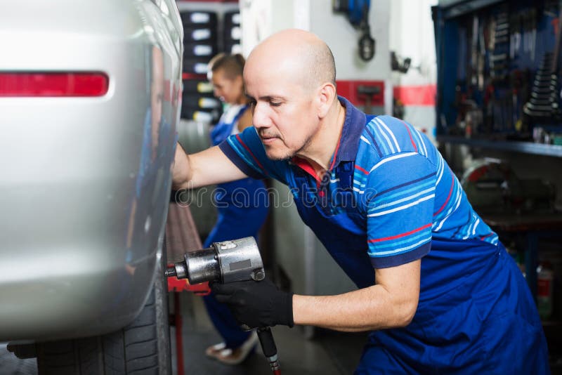Mechanic Man Working With Tire Stock Image Image of mechanism, smiling 93510187