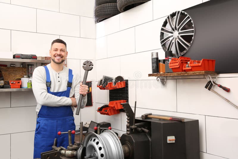 Mechanic Near Car Disk Lathe Machine at Tire Service Stock Image
