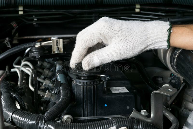 A Mechanic is Opening the Oil Cap from a Car Engine. Stock Image