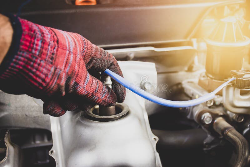 The Mechanic is Opening Oxygen Sensor O2 in the Exhaust Pipe for