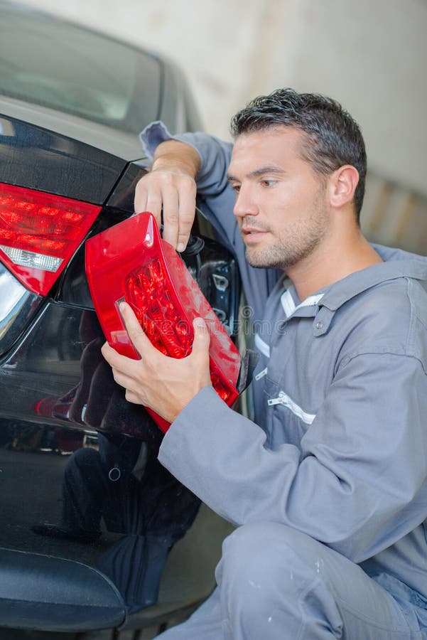 Mechanic Replacing a Headlight Stock Image Image of gudgeon, plug