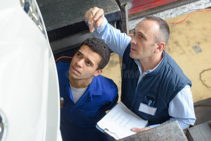 Mechanic Teaching Trainee in Garage Stock Photo Image of