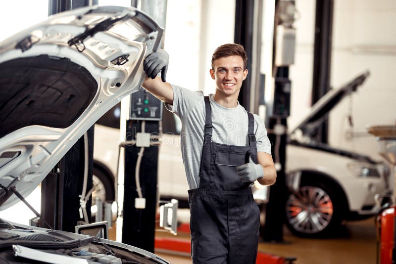 A Mechanic in Uniform is Standing Near a Car Stock Image Image of