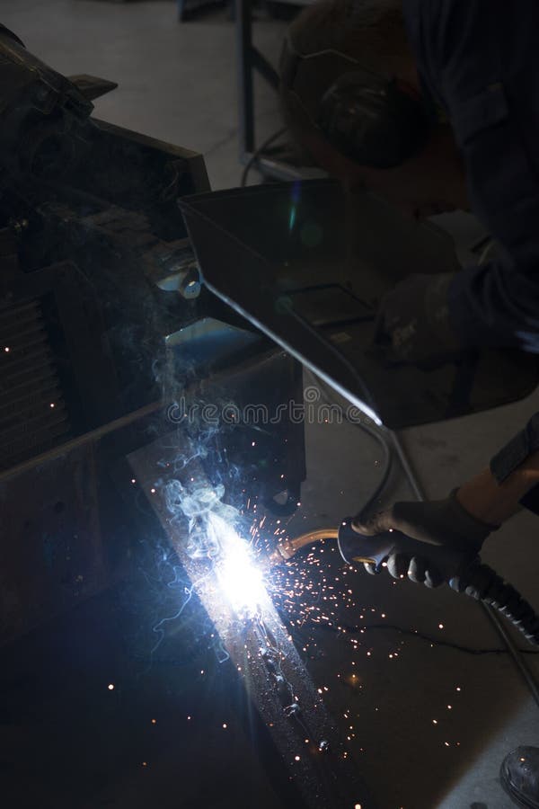 Mechanic welding under car stock image. Image of spark 8229993