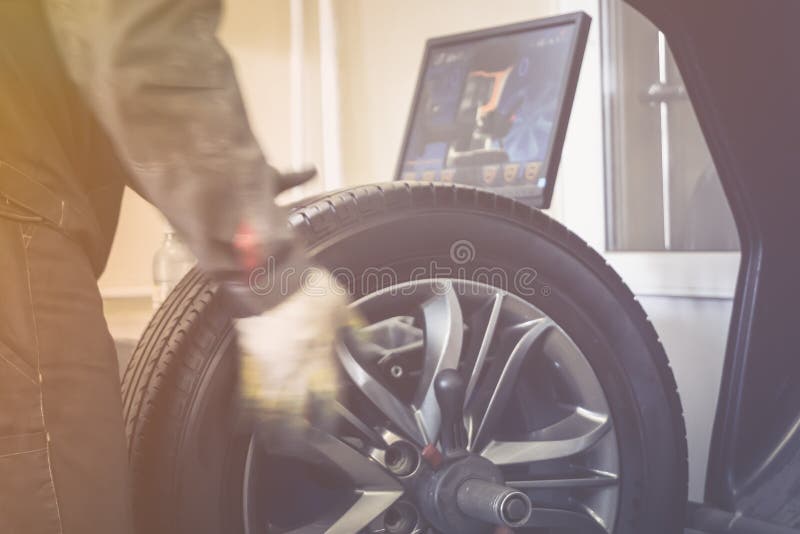 Mechanic Worker Makes Computer Wheel Balancing on Special Equipment