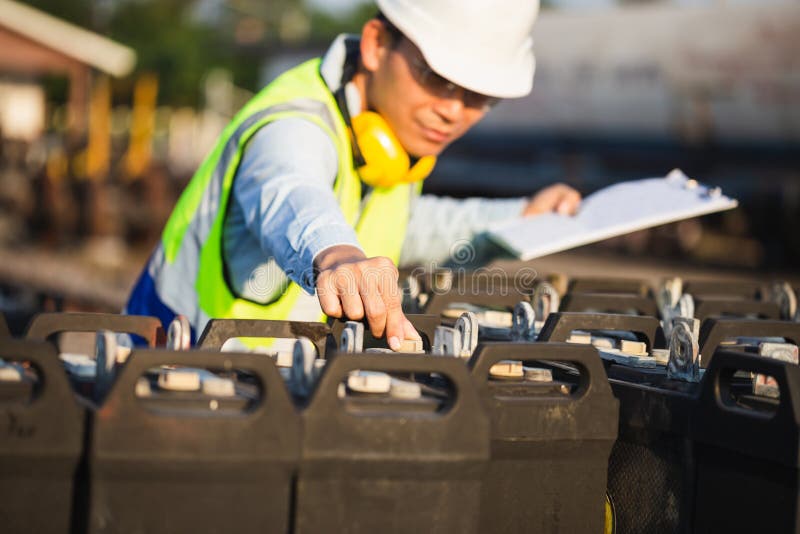 Engineer Man Checking of the Battery Storage System with Solar Panels
