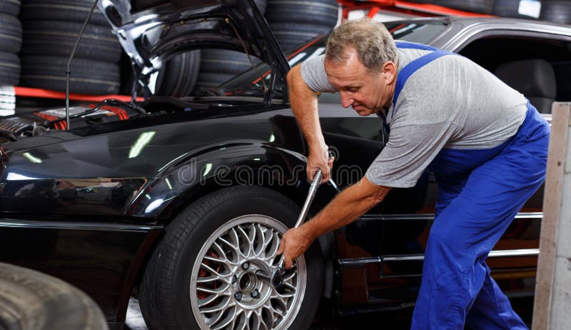 Mechanician changing car wheel